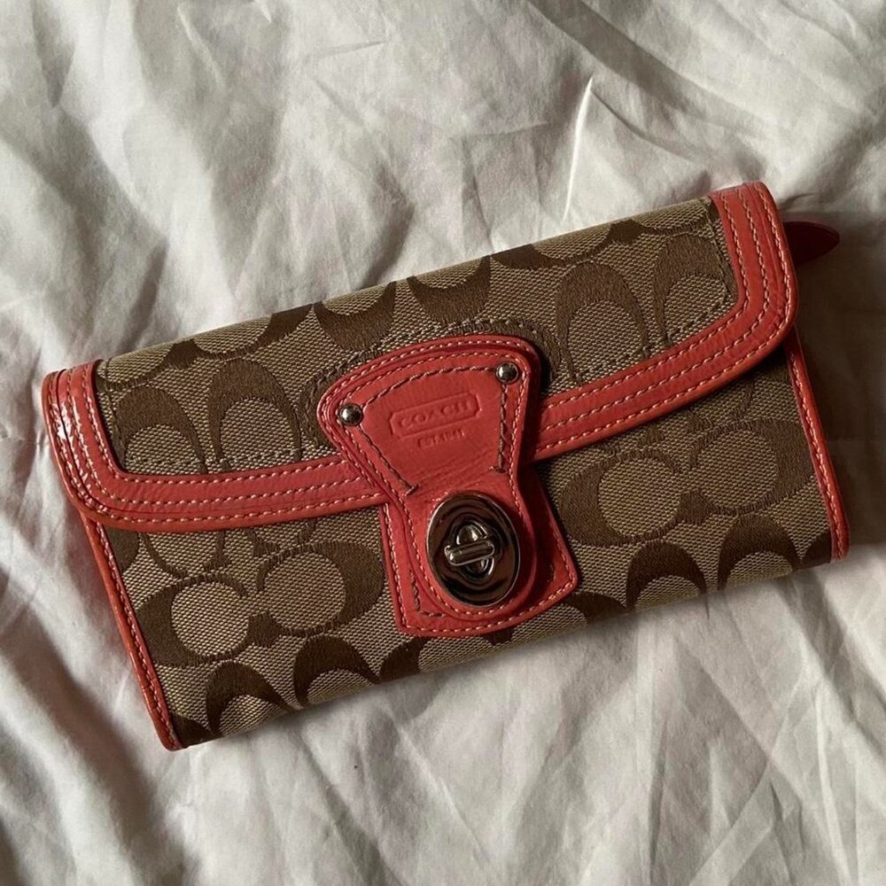 coach slim legacy wallet with signature locket and a coral pink lining
